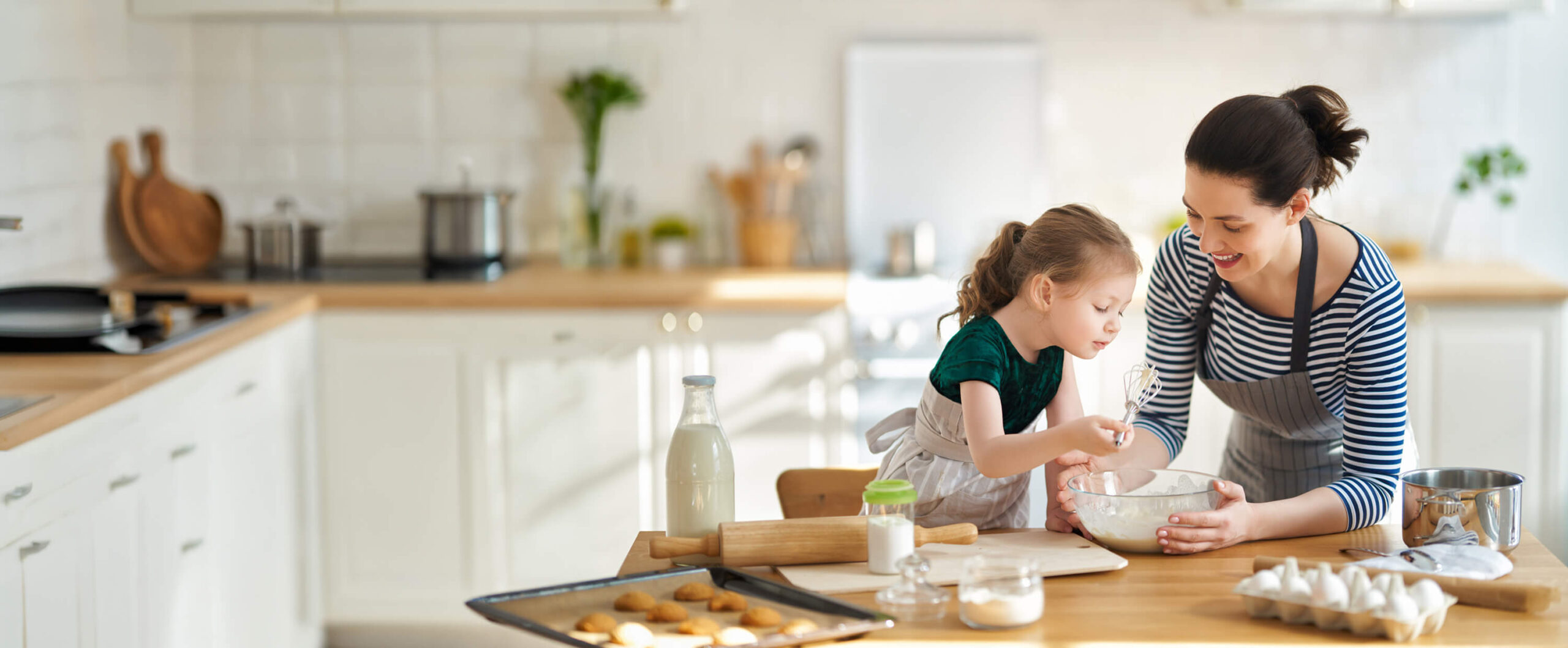 mother and daughter working on kitchen